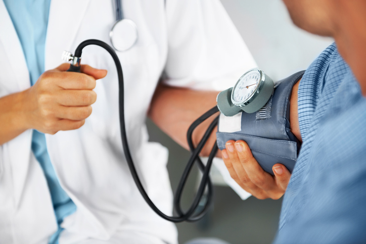 Doctor checking blood pressure